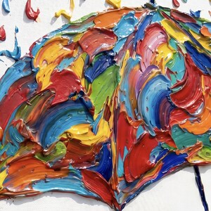 May include: A textured oil painting on canvas featuring a multi-colored umbrella depicted with thick, impasto brushstrokes. The umbrella is composed of vibrant red, blue, yellow, orange, and green paint, with matching colorful rain droplets.