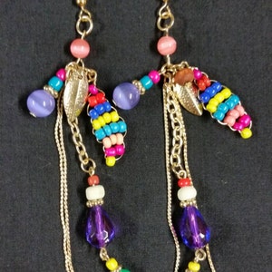 A pair of funky gold hook earrings with a colorful bead mix