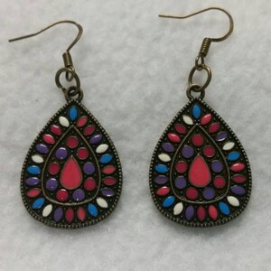 Antique gold teardrop shaped earrings with pink white purple and blue decoration