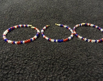 A set of 3 red, white, and, blue bracelets