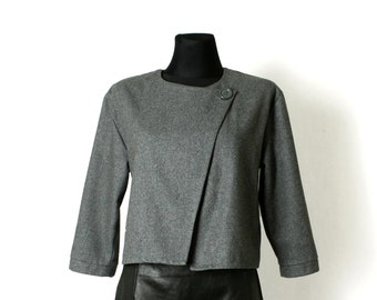 May include: A gray cropped jacket with a single button closure and a black leather skirt.