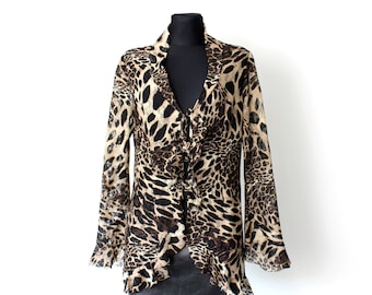 May include: A brown and black leopard print long-sleeved blouse with a ruffled hem and a V-neck.