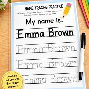 May include: A laminated name tracing practice sheet with a light blue border, featuring the text 'NAME TRACING PRACTICE', 'My name is..', and the name 'Emma Brown' in solid and dotted fonts. A black dry erase marker is included on the side.