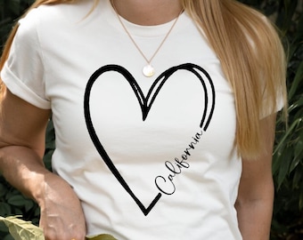 May include: White t-shirt with a black hand-drawn heart design and the text "California" inside the heart.