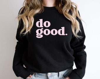 Op de afbeelding: Zwart sweatshirt met de tekst "do good." in roze.