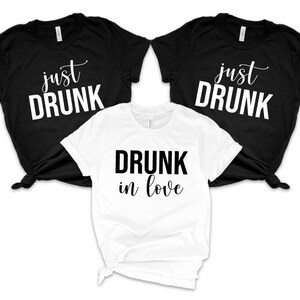 May include: Three t-shirts with the text "just drunk" on two black shirts and "drunk in love" on a white shirt.