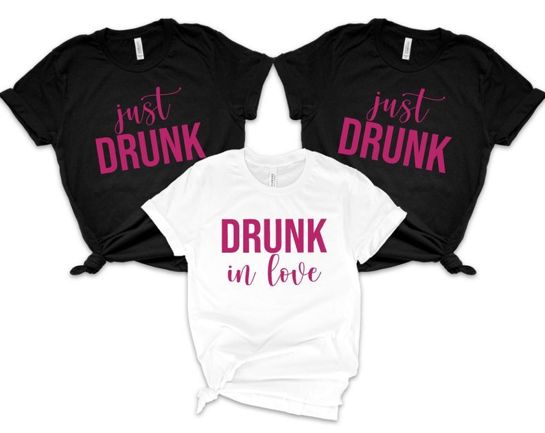 May include: Three t-shirts with the text "just drunk" and "drunk in love" in pink lettering on a black and white background.