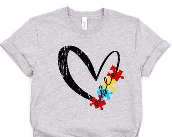 May include: Gray t-shirt with a black heart and puzzle pieces that spell "whole" in black script.
