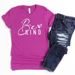 May include: A magenta t-shirt with the text "Be Kind" in white with a small heart symbol.