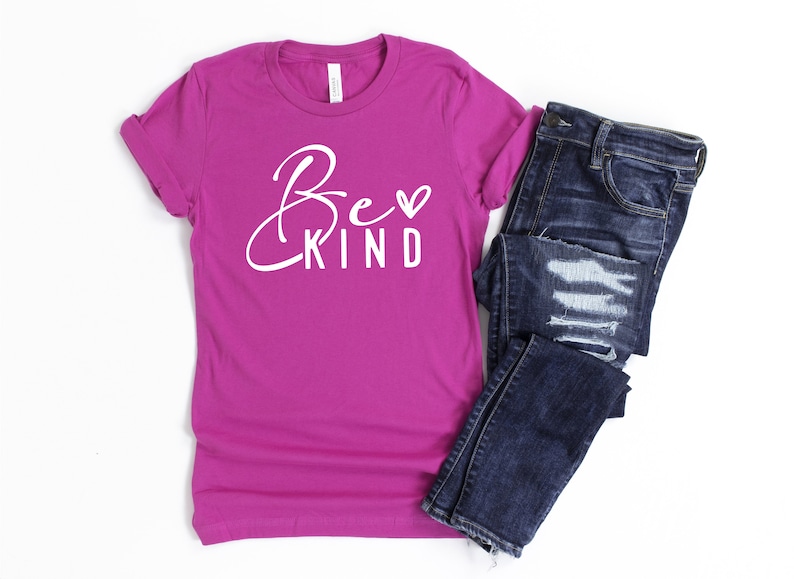 May include: A magenta t-shirt with the text "Be Kind" in white with a small heart symbol.