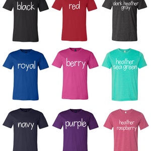 May include: Nine t-shirts in different colors, each with a different color name printed in white on the front. The colors are black, red, dark heather gray, royal blue, berry, heather sea green, navy, purple, and heather raspberry.
