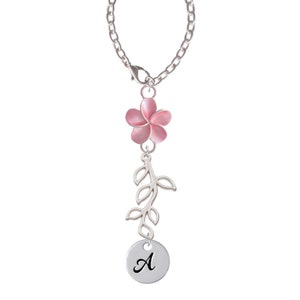 May include: Silver chain necklace with a pink flower charm, a silver branch charm, and a silver disc charm with the letter A.