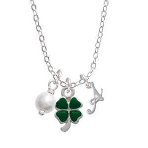 May include: A silver chain necklace with a green four-leaf clover charm, a pearl bead, and a silver letter 'A' charm.
