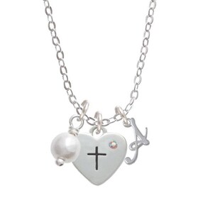 May include: Silver necklace with a heart charm featuring a cross, a pearl, and a letter 'A' charm. The necklace also includes a separate heart charm with a fish symbol.