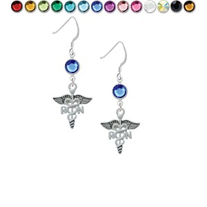 May include: Silver earrings with a caduceus charm and a blue crystal. The charm has the letters "RN" on it.