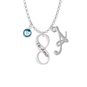 May include: Silver necklace with a blue crystal charm, an infinity symbol charm with the words "Te Amo" engraved on it, and a cursive letter "A" charm.