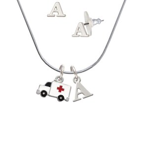 May include: A silver necklace with a charm of a white ambulance with a red cross and a silver letter A charm. The necklace comes with a pair of silver stud earrings with the letter A.