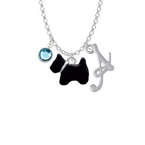 May include: Silver necklace with a black silhouette of a dog, a blue crystal charm, and a silver letter A charm.
