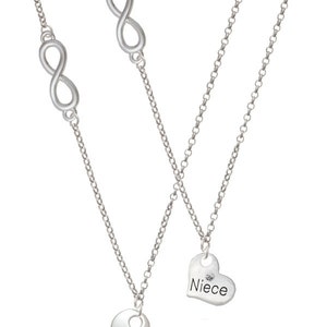 May include: Two silver necklaces with infinity symbols and heart pendants. The heart pendants have a small diamond and the words "Aunt" and "Niece" engraved on them.