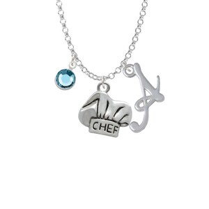 May include: Silver necklace with a blue crystal charm, a chef hat charm with the word "CHEF" on it, and a cursive letter "A" charm.