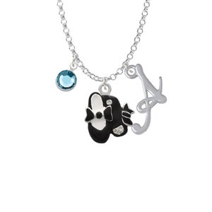 May include: Silver necklace with a black and white shoe charm, a blue crystal charm, and a silver letter A charm.