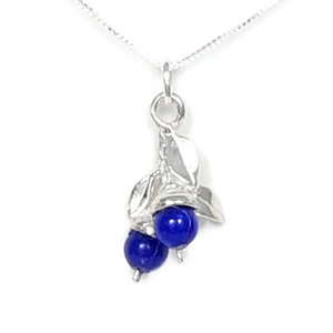 May include: A silver necklace with a pendant featuring two blue lapis lazuli stones set in a silver leaf design.