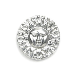 May include: A silver sun pendant with a detailed face and rays. The pendant is round and has a textured surface.