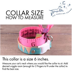May include: A pink measuring tape wrapped around a teal and tan cat collar. The collar is size 15 cm. Text reads "COLLAR SIZE HOW TO MEASURE" and "This collar is a size 6 inches."