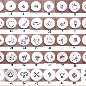 May include: A set of 48 metal stamp designs for jewelry making. The stamps are shown on 1/2 inch wide aluminum rounds. The designs include hearts, stars, animals, plants, and more.