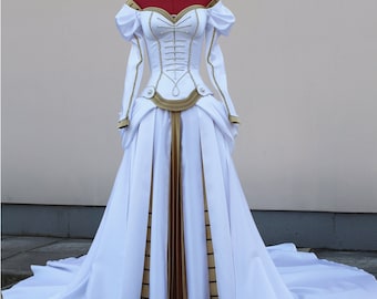 May include: A white wedding dress with a gold and white corset bodice and a long train. The dress has a sweetheart neckline and long sleeves.