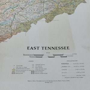 May include: A vintage map of East Tennessee, featuring a detailed depiction of the region's counties, highways, and natural features. The map includes a scale in miles and kilometers, a legend, and a population key. The text "EAST TENNESSEE" is prominently displayed.