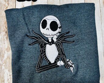 Celebrate the season with our cozy embroidered sweatshirt featuring Jack Skellington!