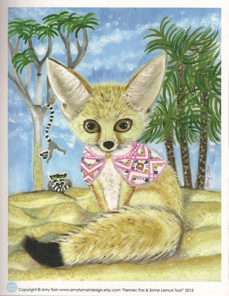 May include: A painting of a fennec fox wearing a pink and white patterned scarf. The fox is sitting on a sandy surface with palm trees in the background. The painting is titled "Fennec Fox & Some Lemurs Too!" and is signed by the artist, Amy Tom.