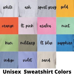 May include: A chart showing 16 different color options for unisex sweatshirts. The colors include white, ash, sport gray, gold, orange, light pink, azalea, mint, kiwi, military, light blue, sapphire, indigo, violet, and sand.