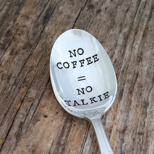 May include: A silver spoon with the text "NO COFFEE = NO TALKIE" engraved on the front.