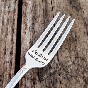 May include: A silver fork with the words "I'm Done 9.30.2020" engraved on the handle.