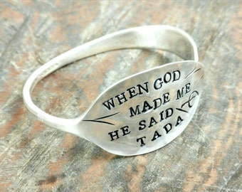 May include: A silver spoon bracelet with the words "When God Made Me He Said Tada" engraved on the spoon.