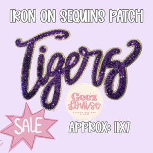 May include: An iron-on patch featuring the word Tigers in purple sequins with a gold border. The text is written in a cursive script style. The image includes the text Iron On Sequins Patch, a circular logo for Geez Louise, and a pink starburst with Sale.