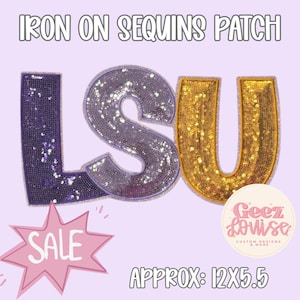 May include: An iron-on sequin patch featuring the letters LSU in purple and gold. The L is purple, the S is purple, and the U is gold. The patch measures approximately 12 inches by 5.5 inches. Text on the image reads IRON ON SEQUINS PATCH, SALE, and Geez Louise.
