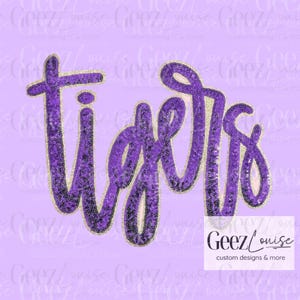May include: A purple sequined patch featuring the word tigers in a cursive script font. The letters are outlined in a thin gold border, creating a textured and reflective appearance against the light purple background with a watermark logo.