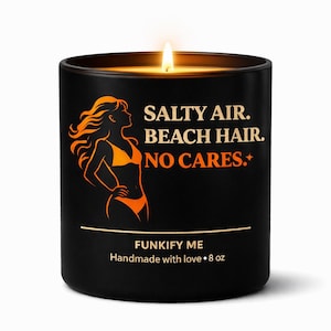 May include: A black candle with a lit flame. The candle features a silhouette of a woman in a bikini, with the text "SALTY AIR. BEACH HAIR. NO CARES." in white and orange. The candle is labeled "FUNKIFY ME" and "Handmade with love • 227 g."