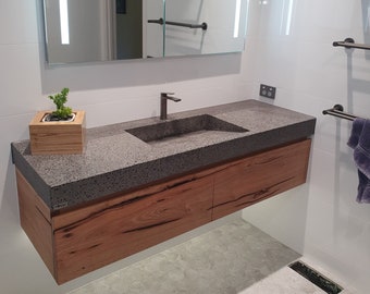 Concrete and hardwood floating exposed aggregate concrete vanity with concrete sink, real concrete top with hardwood cabinetry.