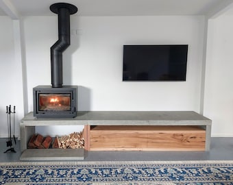 Concrete fire hearth, tv unit, plinth, open fire stand with cabinetry. Handmade polished concrete floating bespoke hearth, concrete bench.
