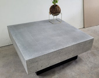 Apartment style polished concrete square coffee table with black base, 700mm x 700mm. Handmade table, bespoke custom industrial look.