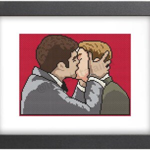 May include: Cross-stitch pattern of two men kissing on a red background. The men are wearing suits and are looking at each other.