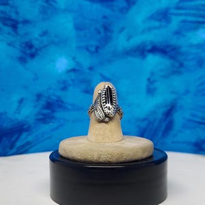 black onyx sterling silver ring, size 5 1/2.  bordered by a large leaf and balls. heavy blossom band (new)