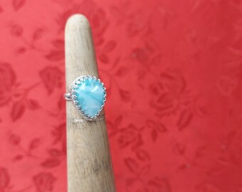 Larimar ring (AAA) size 4 1/2. It is set in a gallery bezel with a plain band. The stone is 18 x 13 mm