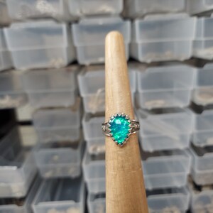 Opal triplet ladies ring with a 10 x 14 mm stone set in a Gallery bezel size 5 1/2 new style band.