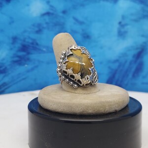 The ring is a size 8 with a 17 x 24 mm Ocean jasper and a very nice rope design heavy band.  Bordered with leaves and small blossoms