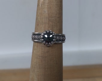 Unisex ring is a 8 mm hematite It is made of sterling silver size 9  3/4. blossom detailed band.